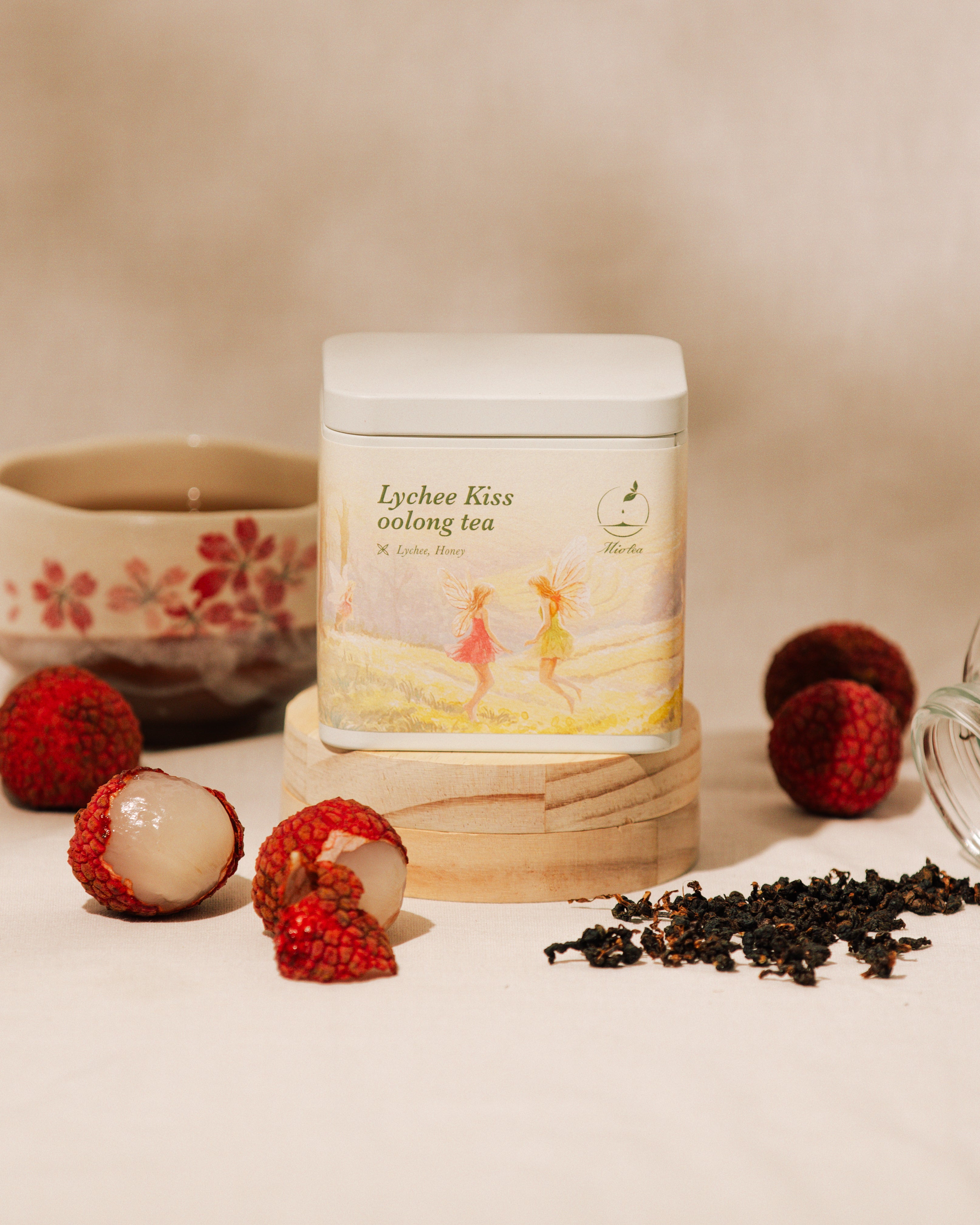 Brewed Lychee Kiss Oolong Tea with loose tea leaves and flower petals.