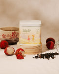 Brewed Lychee Kiss Oolong Tea with loose tea leaves and flower petals.