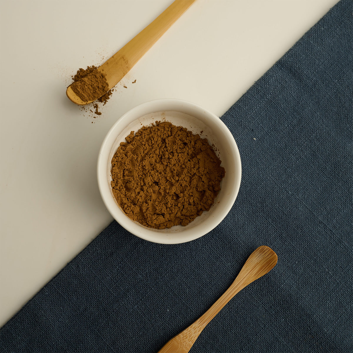 Red Oolong Tea Powder in a bowl with bamboo spoon. 