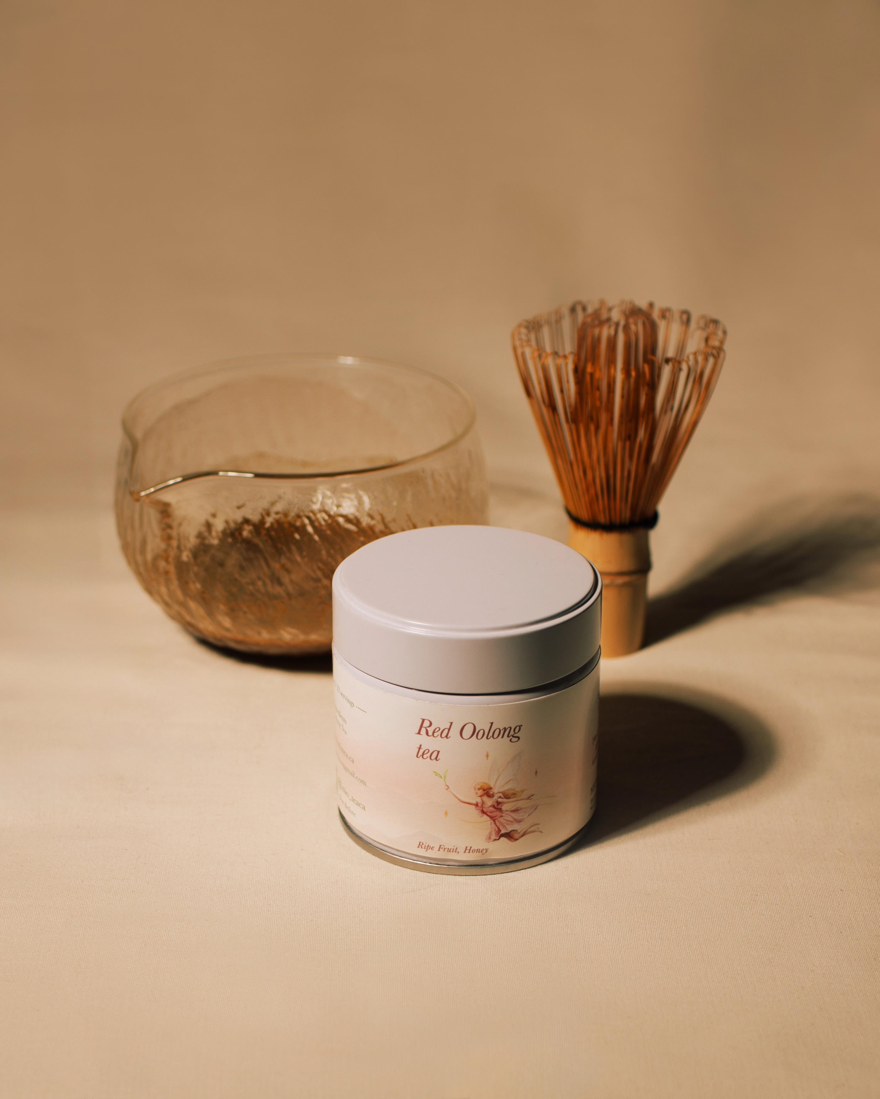 Red Oolong Tea Powder tin with tea bowl and bamboo whisk. 